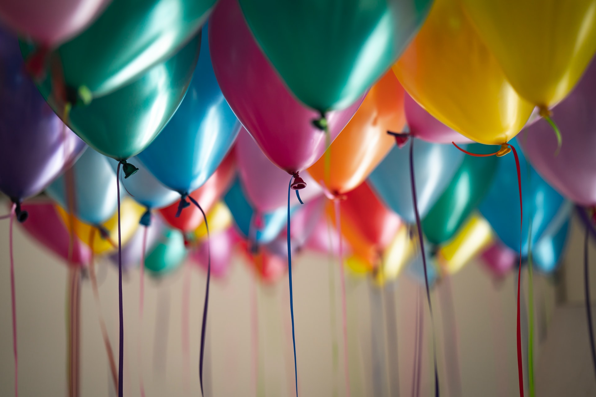 Party balloons with ribbons on a ceiling