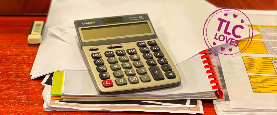 Calculator and expenses paperwork on a desk